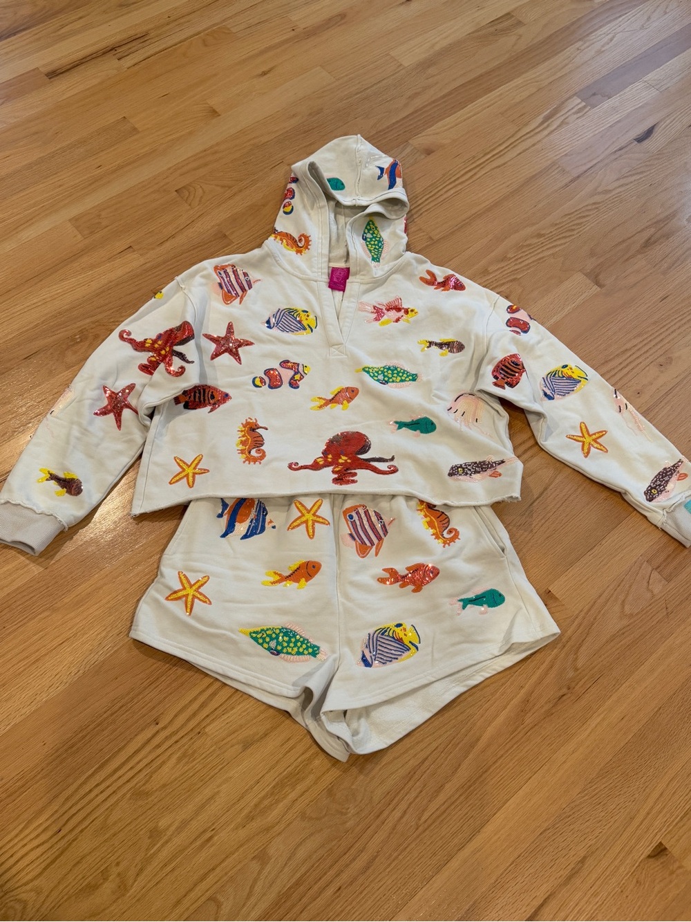 QUEEN OF SPARKLES Cream Hoodie with Colorful Sea Creature Prints